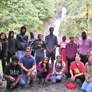 picture of group behind waterfall